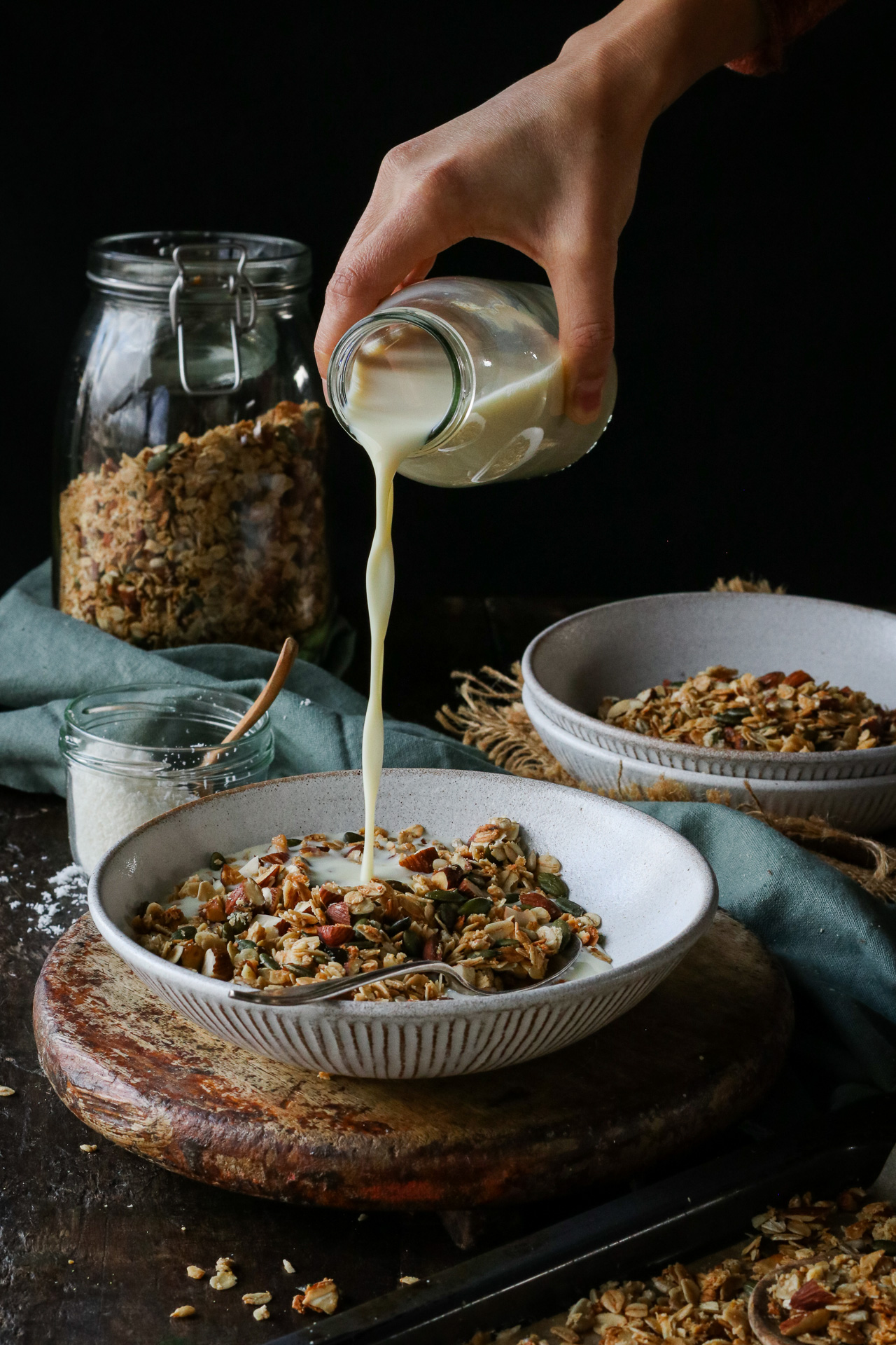 pouring plant-based milk onto granola